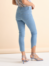 Pantaloni skinny in denim azzurro con borchiette