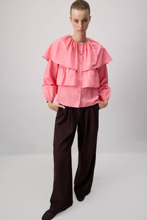 Blusa corta rosa con balze e maniche a sbuffo in misto cotone